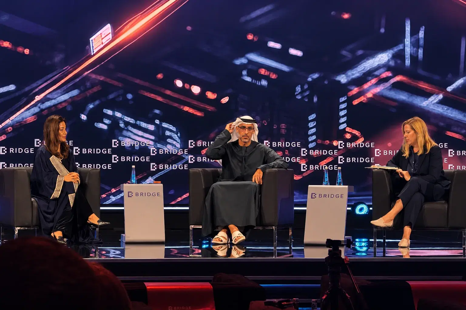 Rachel Maycock on stage at the BRIDGE summit in Abu Dhabi with UAE government representatives