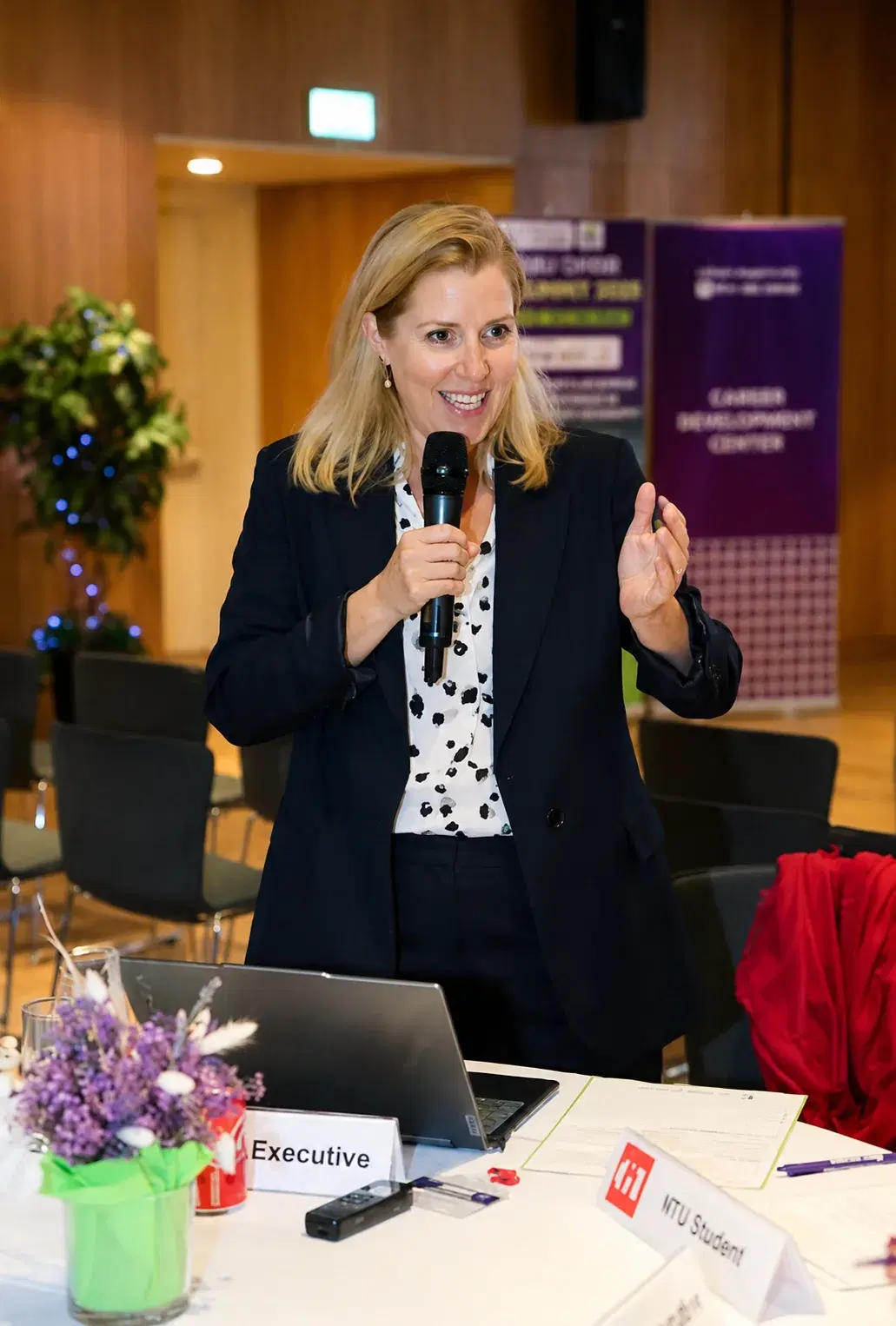 Rachel Maycock briefing a room at a summit in Abu Dhabi